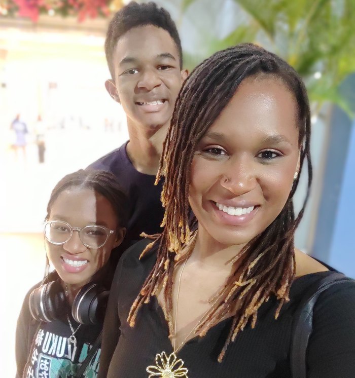 Kiah smiling with her two children